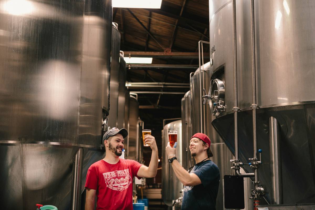 sustainable brand beer tip on how organic craft beer with compostable packaging and barley fields in background